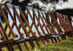 A photograph of a long line of blue and white deckchairs
